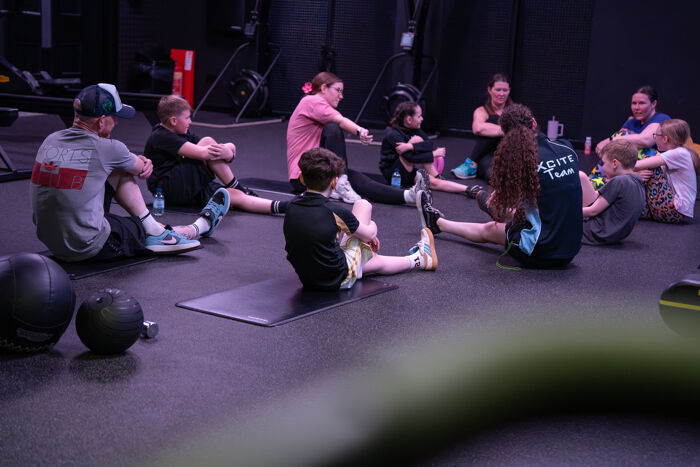 Kids & Adults exercising together.